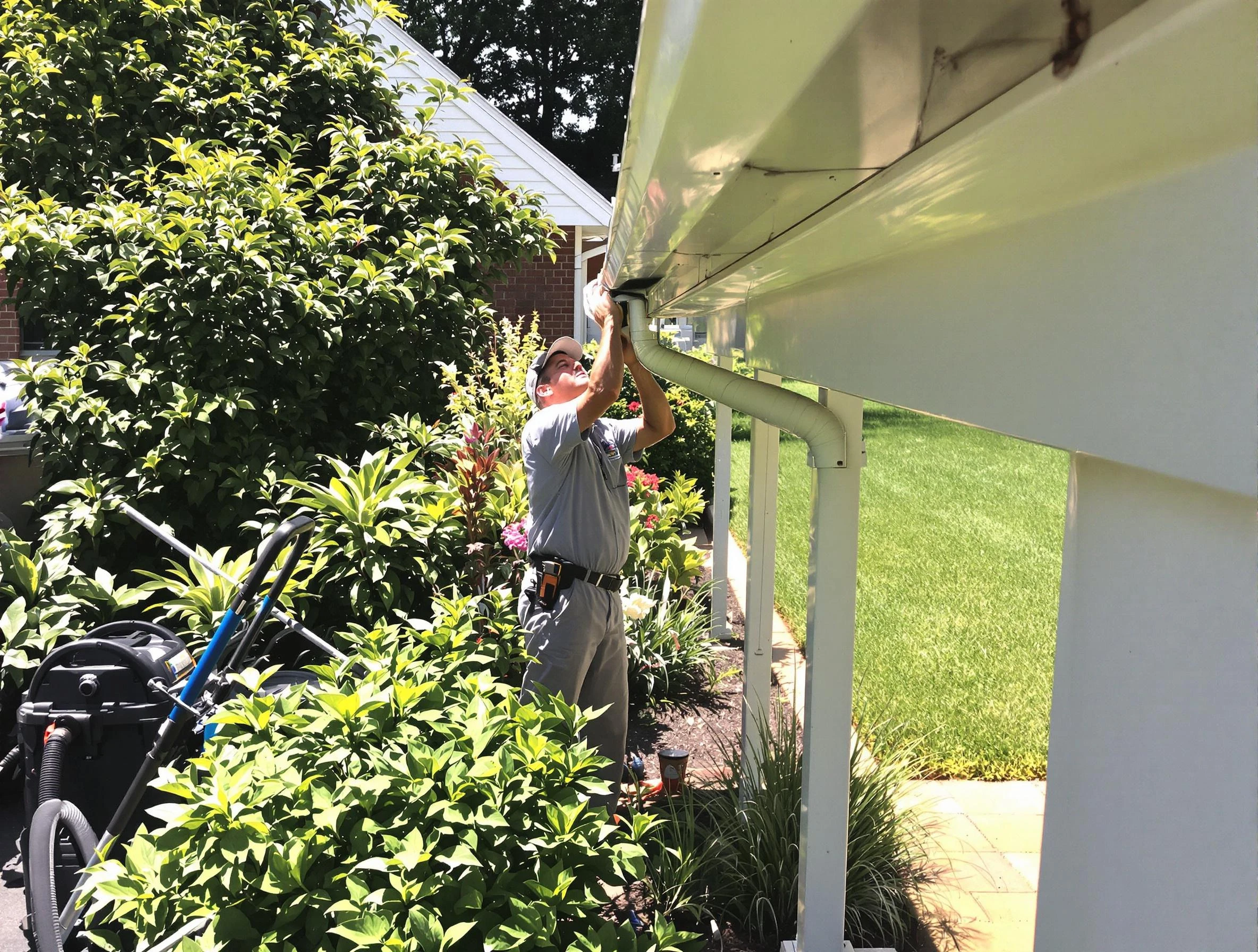 Technician flushing a blockage from a downspout in Macedonia, OH